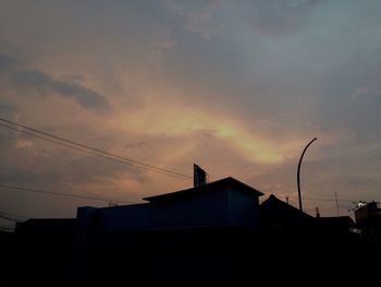 Low angle view of building against cloudy sky