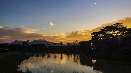 Scenic view of lake against sky during sunset