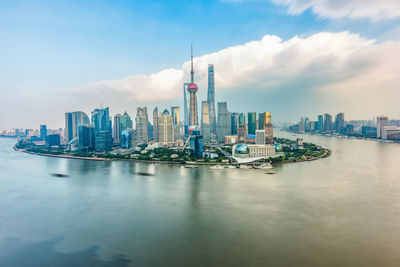 View of city buildings against cloudy sky