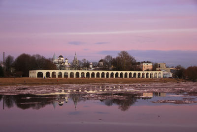Reflection of building in river against sky