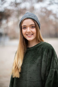 Portrait of smiling woman standing in snow