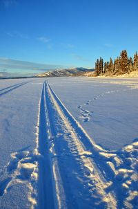 High angle view of tire track on snow covered field