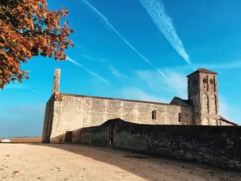 Low angle view of built structure against blue sky