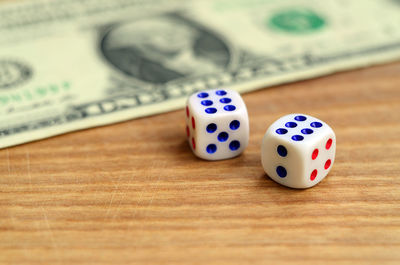 Close-up of dice and paper currency on table