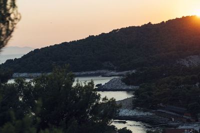 Scenic view of river and mountains against clear sky