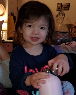 Portrait of happy girl sitting at home