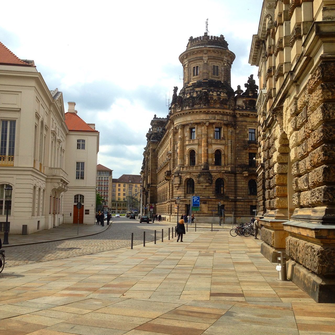 architecture, building exterior, built structure, sky, cobblestone, the way forward, city, history, street, men, incidental people, travel destinations, cloud - sky, building, person, steps, old town, cloud, walking