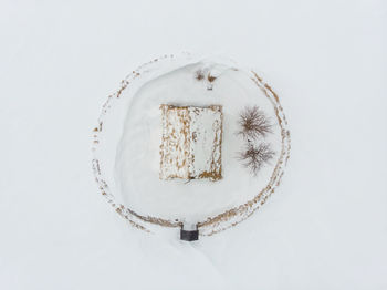 Top view of truf church on snow over white background