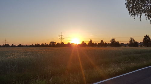 Scenic view of field against sky during sunset