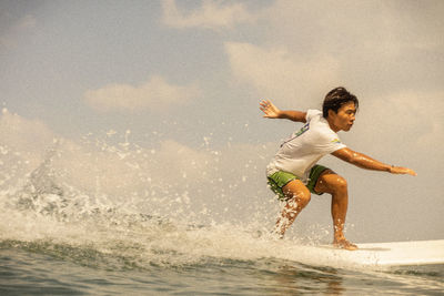 Man surfing on sea shore