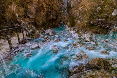 High angle view of river flowing through rocks