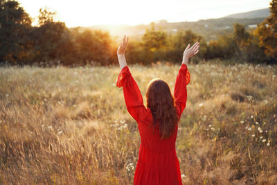 Rear view of woman standing on field