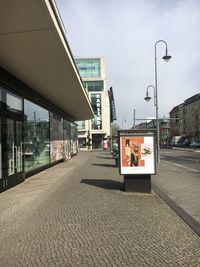 Road by street against sky in city