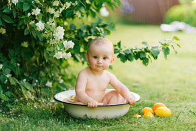 Portrait of cute baby boy in bathtub