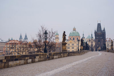 Charles bridge in town against sky