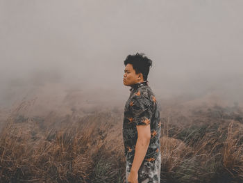 Full length of man standing on field against sky