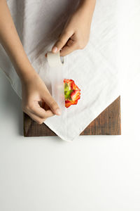 High angle view of woman holding paper