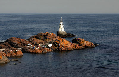 Scenic view of sea and rocks against sky