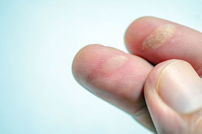 Close-up of hand over white background