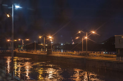 Illuminated city against sky at night