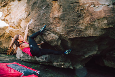 Woman climbing on rock formation