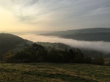 Scenic view of landscape against cloudy sky