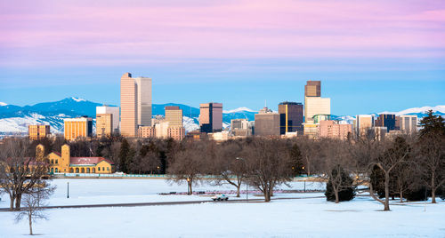 Snowy winter denver morning panorama with city park in foreground skyline and rockies in background