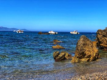 Scenic view of sea against clear blue sky