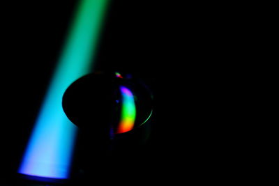 Close-up of illuminated lights over black background