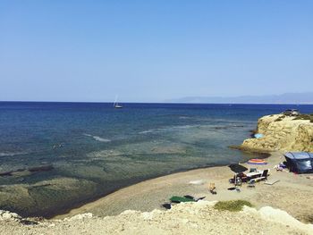 Scenic view of beach against blue sky