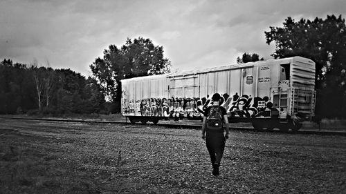 Full length of woman standing against sky