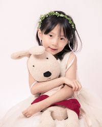 Cute girl with toy against white background