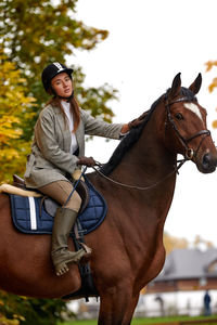 Portrait of young woman riding horse