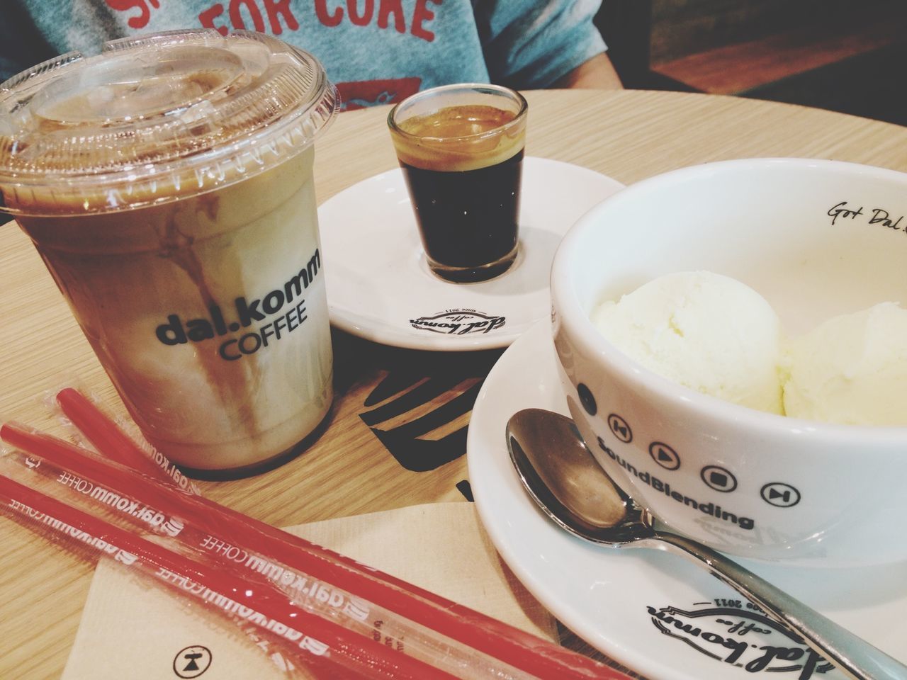 food and drink, indoors, drink, text, western script, freshness, table, refreshment, communication, still life, coffee - drink, coffee cup, food, close-up, high angle view, spoon, drinking glass, no people, frothy drink, saucer