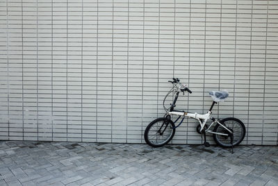 Bicycle parked against wall