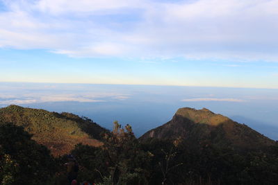 Scenic view of mountain against cloudy sky