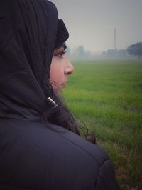 Portrait of woman on field against sky