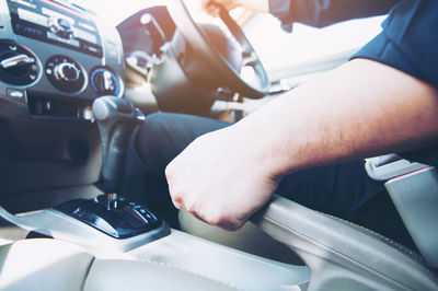 Midsection of man driving car