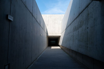 Footpath amidst buildings against sky
