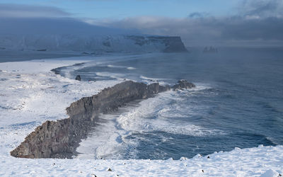 Scenic view of sea against sky during winter