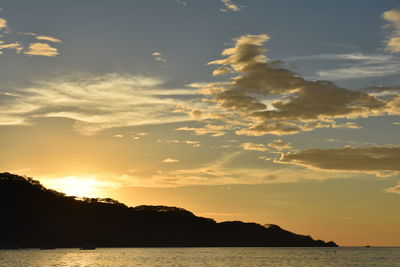 Scenic view of silhouette against sky at sunset