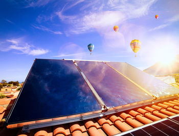 Low angle view of hot air balloon against blue sky