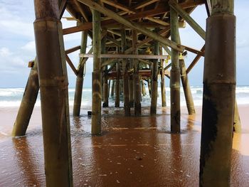 Wooden pier on sea against sky