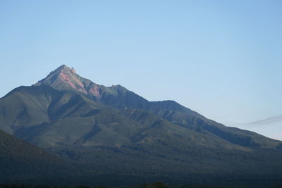 Scenic view of mountains against clear blue sky