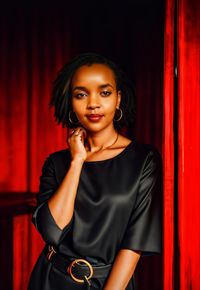 Portrait of young woman standing at home