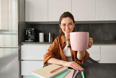 Young woman using mobile phone at home