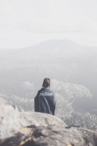 Woman photographing through mountain landscape