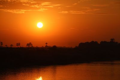 Scenic view of sea against orange sky