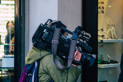 Man photographing through window