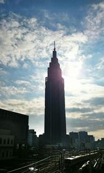 Skyscrapers against cloudy sky